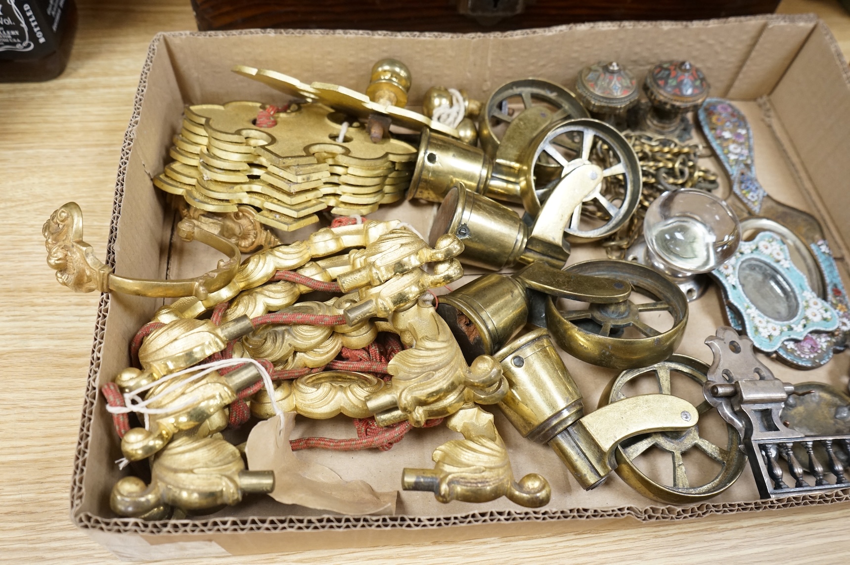A brush grained tin trunk containing brass furniture mounts and fittings and a micromosaic miniature photo frame and hand mirror, trunk 47cm wide (a.f.)
